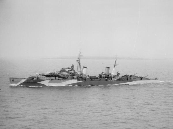 Black-and-white broadside photograph of HMS Charybdis underway, showing her two funnels and four twin main-gun mountings.