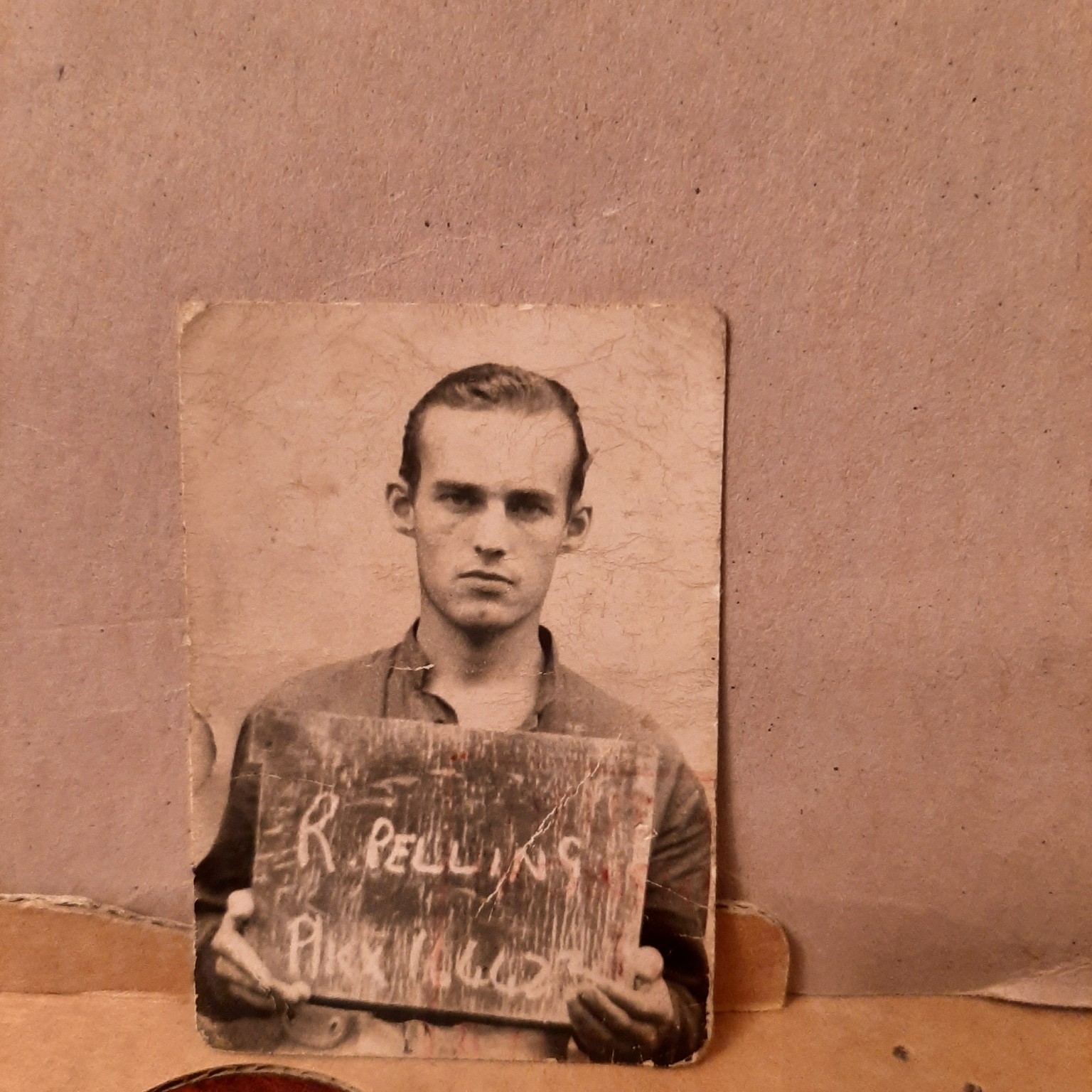 Original family photograph of young Roy Pelling holding an identification board.